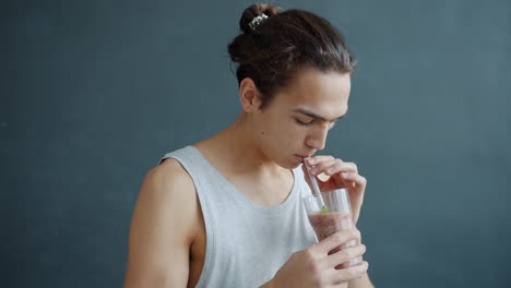 young man drinking smoothie