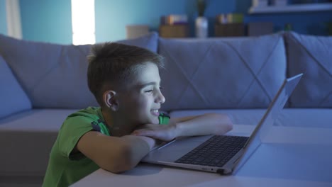 Little-boy-looking-very-closely-at-computer-screen.