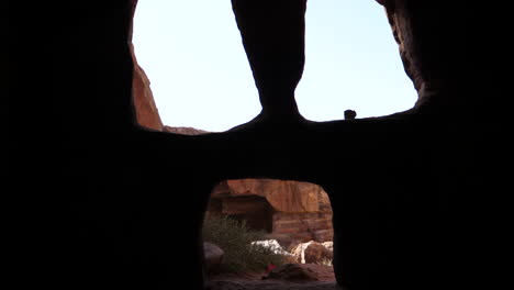 petra unesco archeological world heritage, view from inside a temple monument cave rock carved in the mountains valley of the old jordanian city