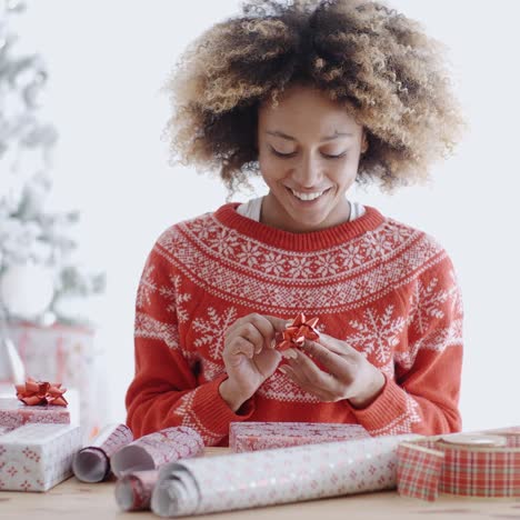 Attractive-young-woman-wrapping-Christmas-gifts