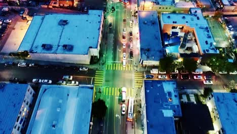 City streets glow with traffic lights as the night descends over Los Angeles