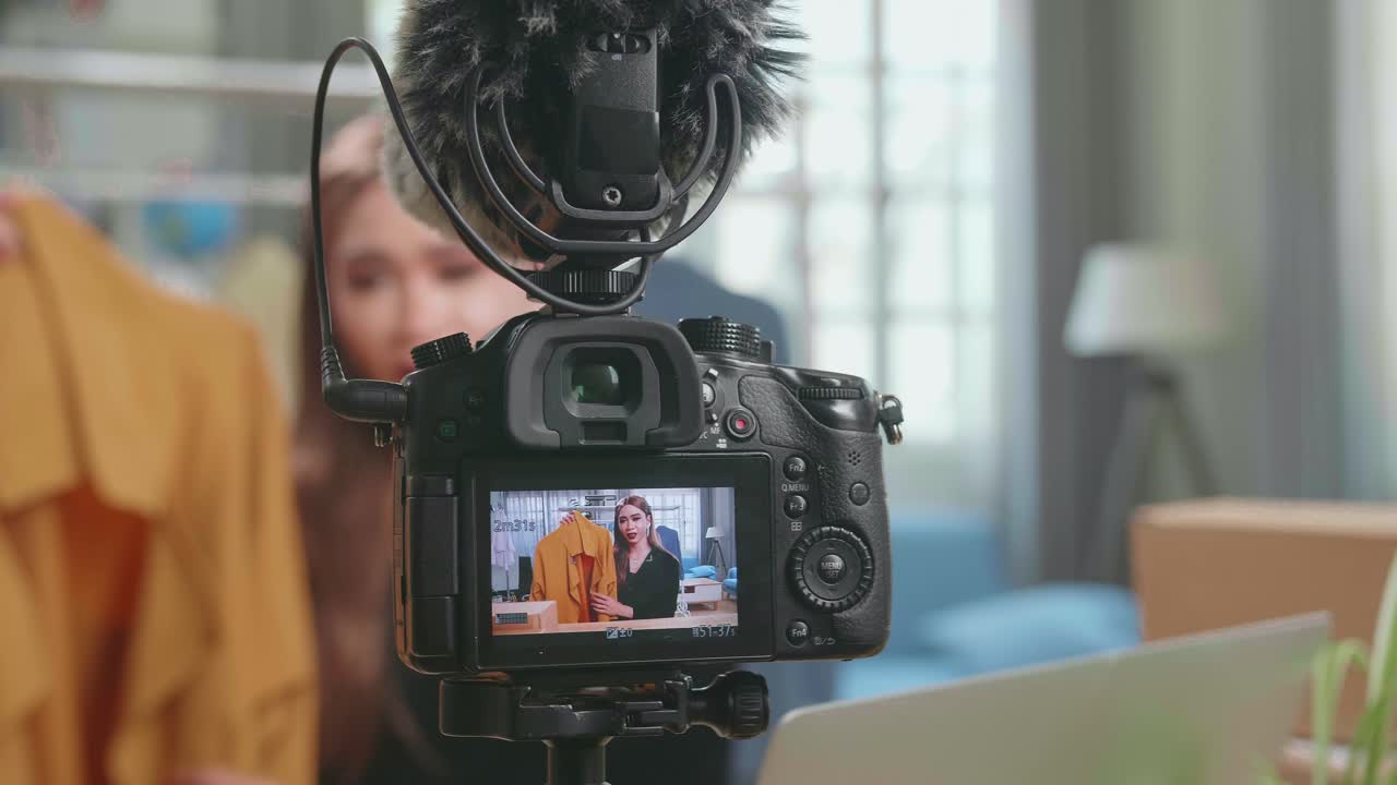 Display Camera Of Fashion Blogger Transgender Woman Showing Casual Colorful Shirts. Stylist Influencer Transgender Woman Showing Trendy Clothes Filming Vlog Episode