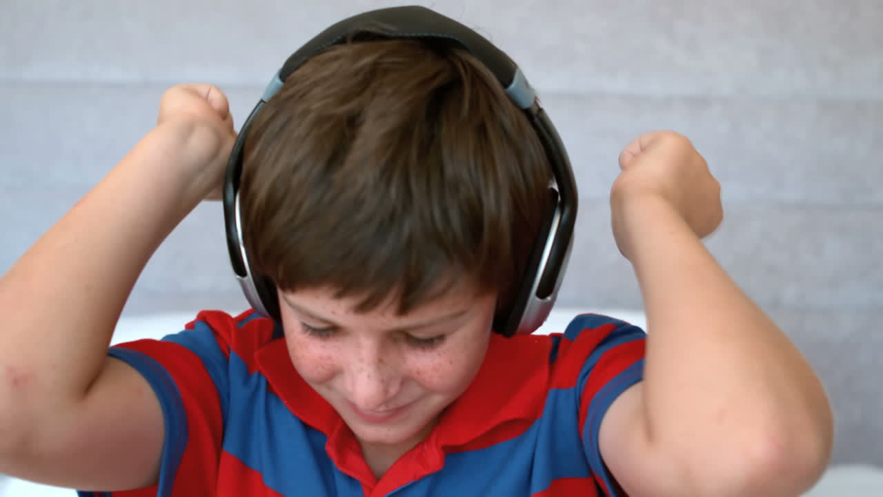 Young boy enjoying music with headphones