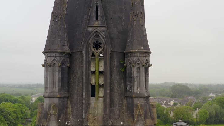 Saint Michael's Church in Ballinasloe Galway with broken wooden windows as birds fly out