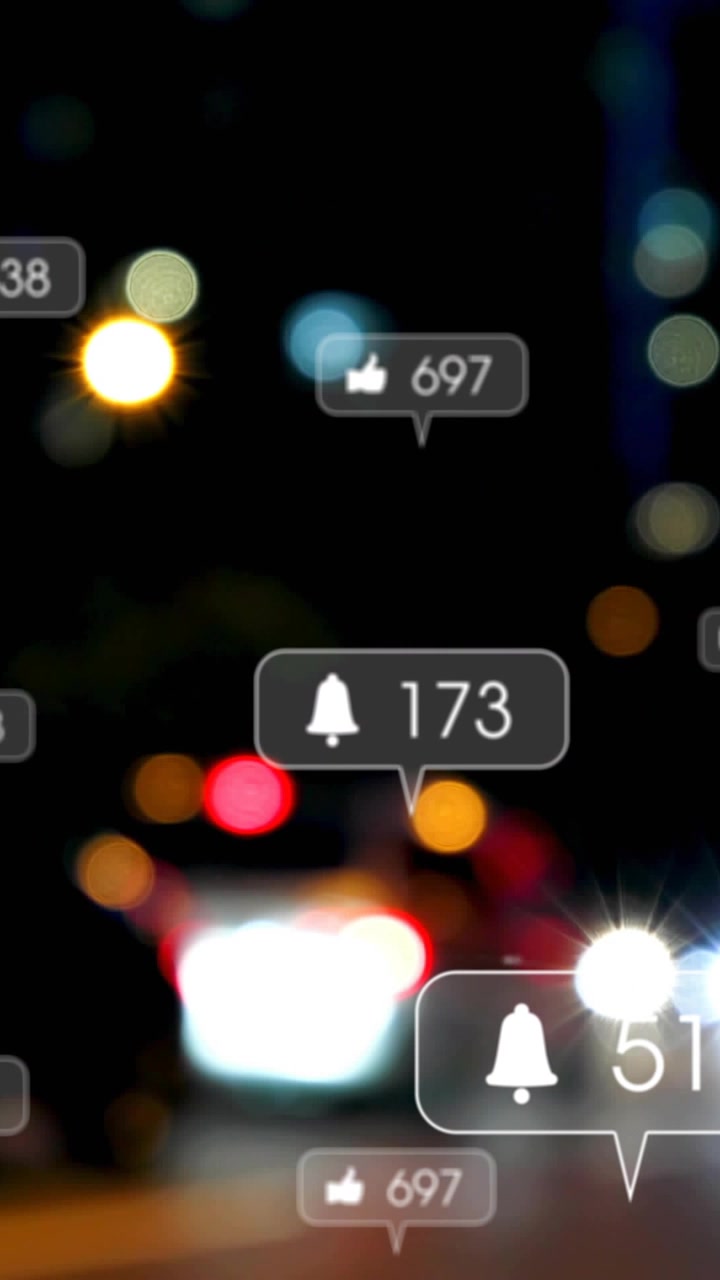 Vertical video: Social alerts popping and updating over bokeh showing bell like comment counts