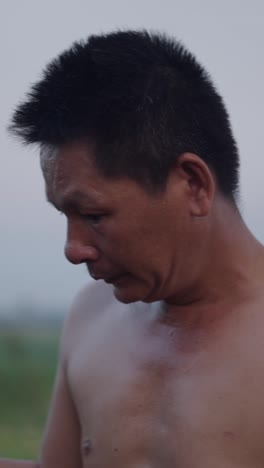 A shirtless man outdoors