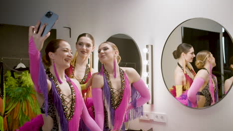 three showgirls taking a selfie in the backstage 1