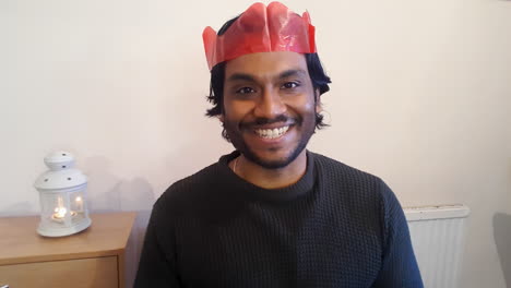 young man on christmas video call talking directly into camera