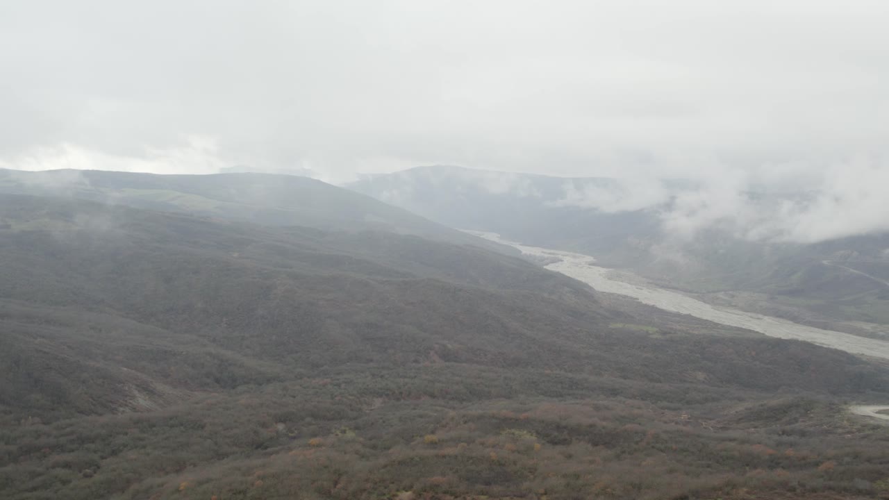 Aerial view of mist-covered hills and winding river near Ismailli. Azerbaijan