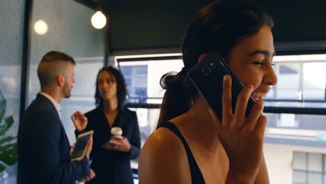 female executive talking on phone in office 4k