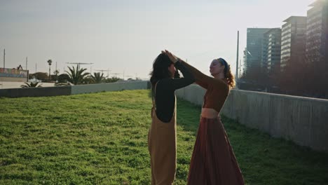 Two women kissing in a city park