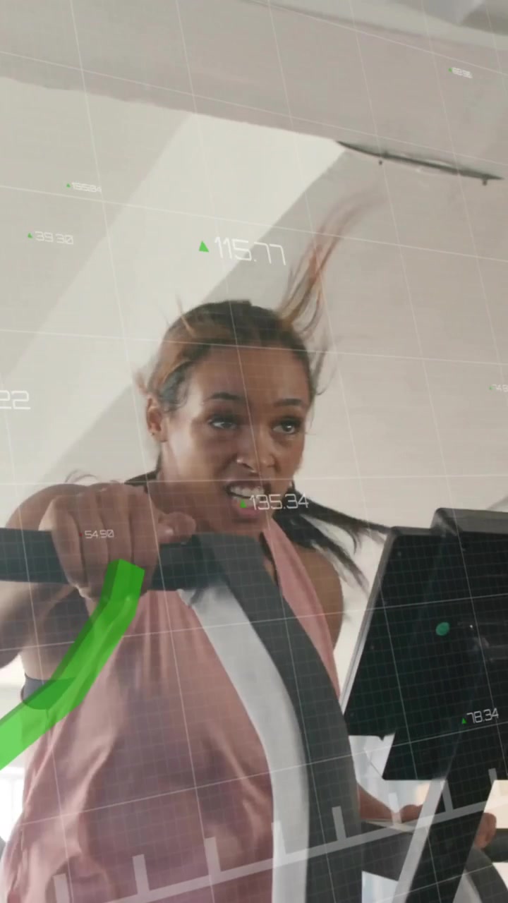 Green financial graph animation over people exercising on stationary bikes in gym