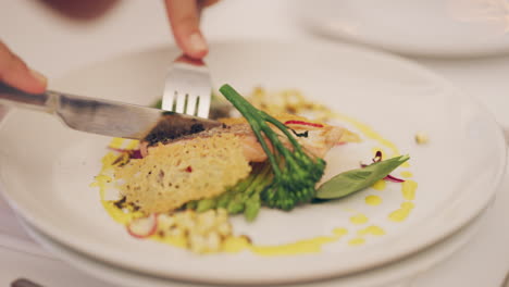 an unrecognizable woman eating a plate of food