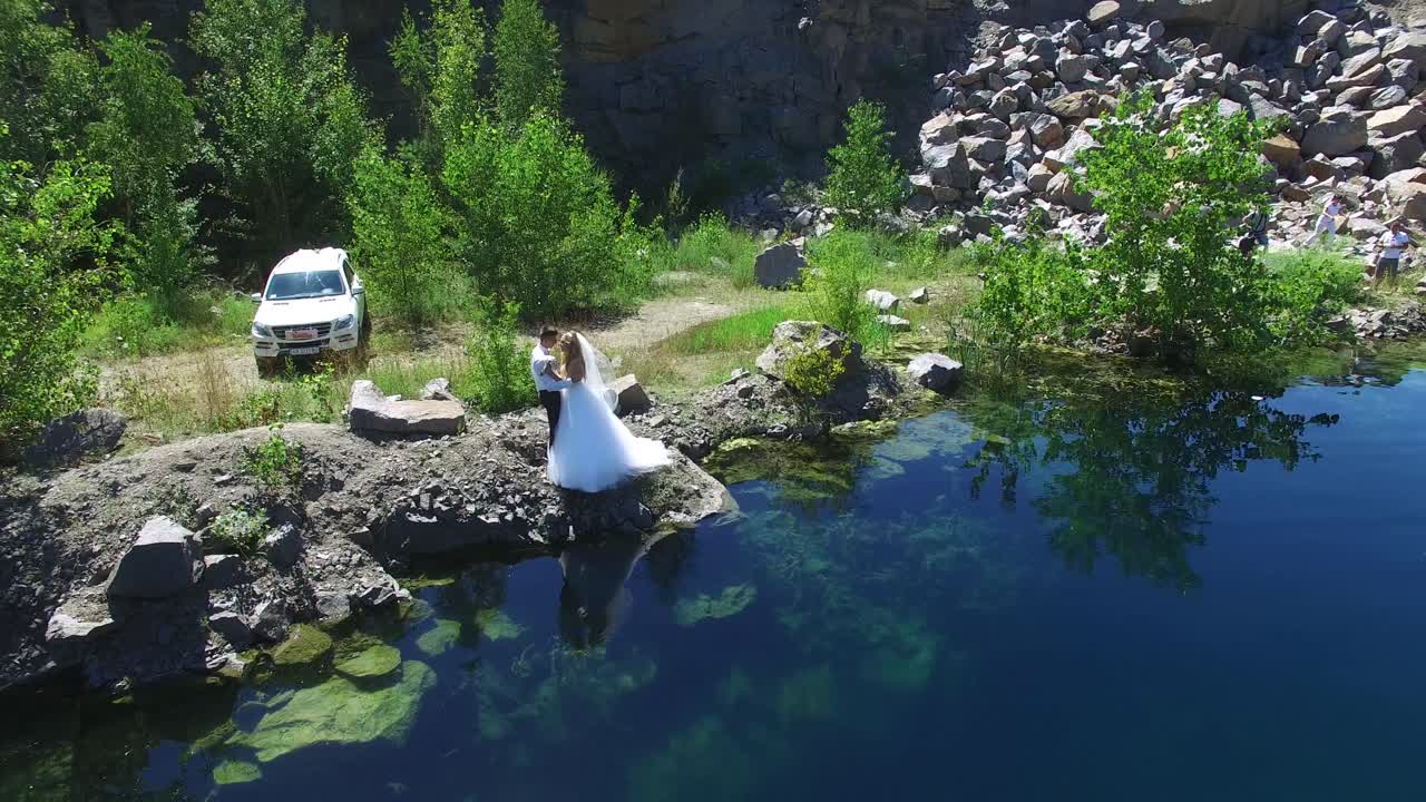 Young Wedding Couple Outdoor. Aerial shot of a young wedding couple outdoor. Groom and bride together