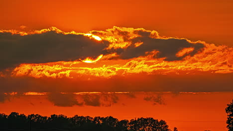 big sun sunset orange between clouds, beautiful colour sky time-lapse