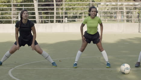 slow motionf of female football players training and warming up at the stadium