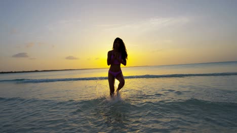 ethnic female in swimwear on tropical ocean beach