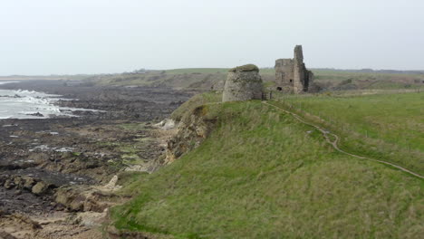 An-aerial-view-of-Newark-Castle-on-the-Fife-coastal-path,-Scotland