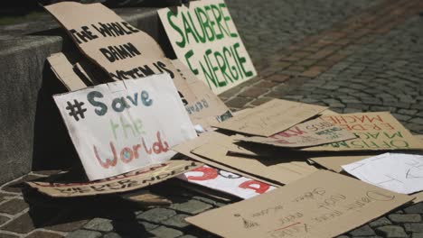 signs of fridays for future demonstrations made out of cardboard laying on the ground