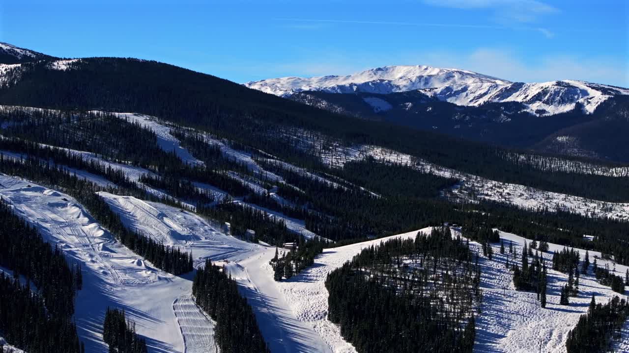 Winter Park Mary Jane Ski Resort moguls early morning blue sky groomed ski trails aerial drone Colorado Dark snowboard ski Territory Cirque double black diamond terrain chairlifts circle right motion