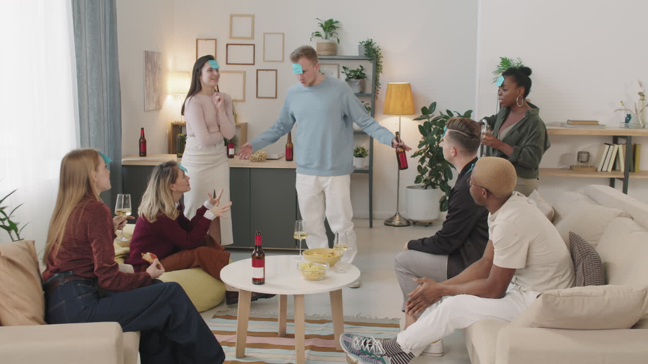 Young People Playing Guessing Game in Apartment