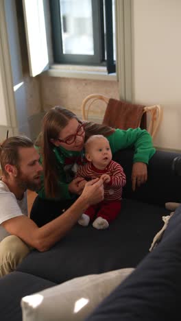 family with baby enjoying christmas time at home