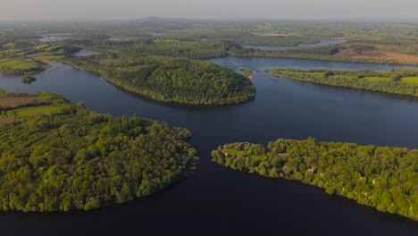 lough oughter, surrounded by lush greenery in county cavan, ireland, aerial view