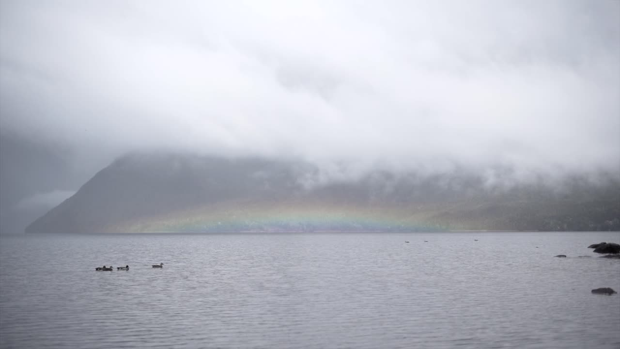 Rainbow over a Misty Lake