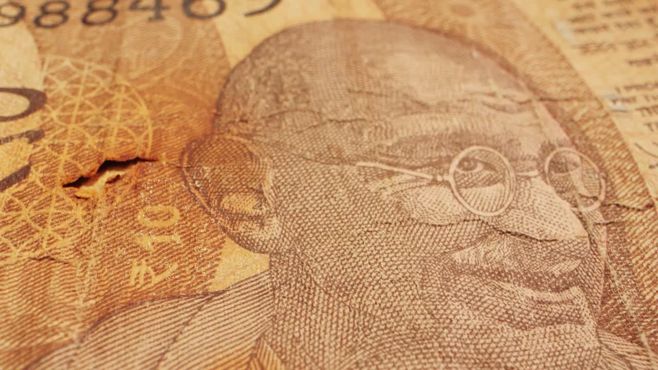 Captivating closeup shots of various currency bills featuring Mahatma Gandhi, including rupees and dollars. Unique onedollar bill with a hole. Money handling and currency art captured in detail