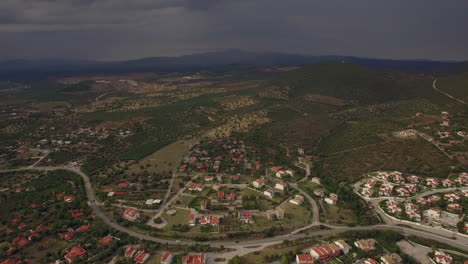 Flying-over-houses-and-green-spaces-in-Trikorfo-Beach-Greece