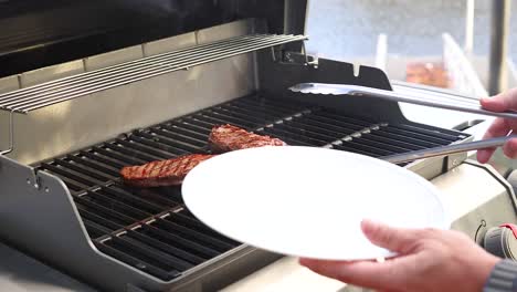 A person grills and serves beef steak on an outdoor barbecue under natural lighting, capturing the cooking process