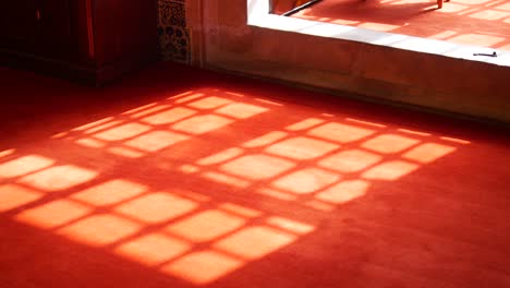 sunlight patterns on red carpet in historical building