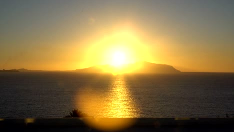 rising sun over the sea and desert mountains