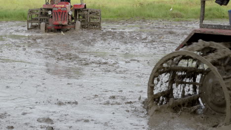 indian farmers tractor working on the rice paddy fields in kerala south india