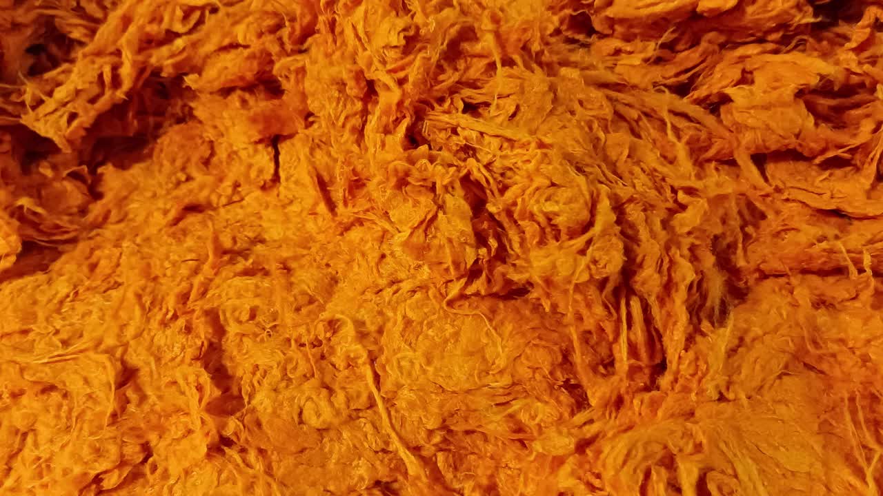 Oranger Baumwollfaser-Hintergrund in Textilgewebe