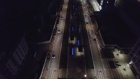 Beautiful-bustling-street-at-night-in-France,panning-aerial-view