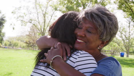 Slow-Motion-Shot-Of-Senior-Mother-With-Adult-Daughter-Hugging-In-Park