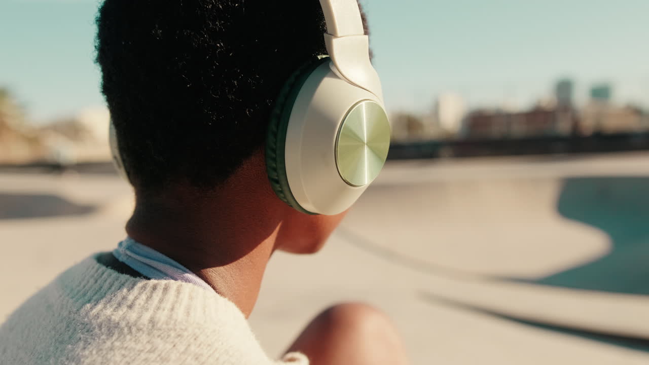 Young Person Wearing Headphones Listening to Music Outdoors