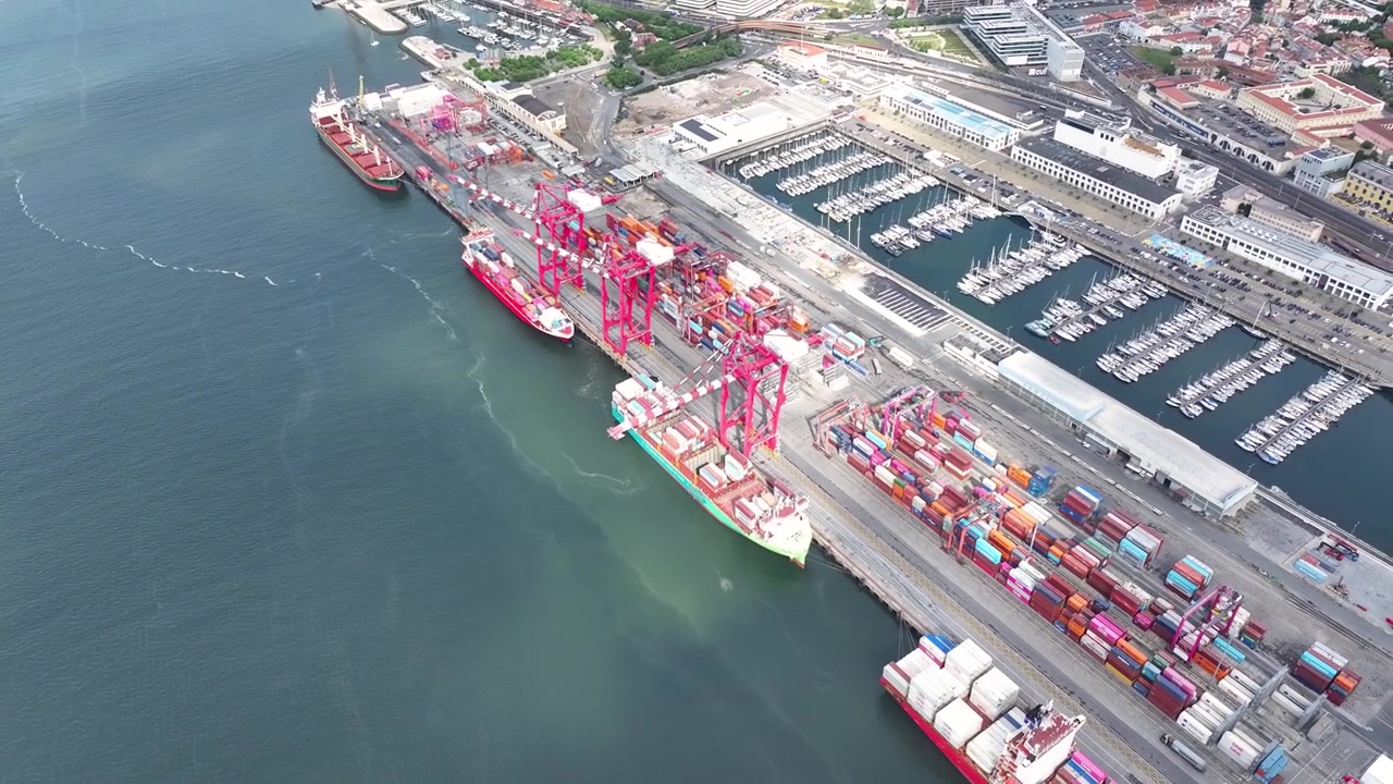 Watch as large container ships dock and unload shipping containers at a busy cargo port. This dynamic environment highlights the vital role of maritime logistics in global trade.