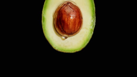 close-up of an avocado half with seed