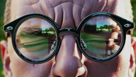 close-up of a man wearing round glasses