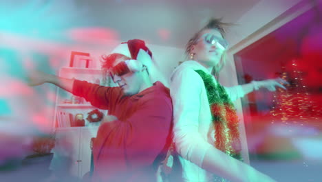 excited couple dancing back to back at home during christmas