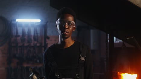 man in safety glasses in a workshop