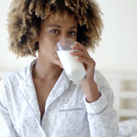 woman drinking a milk on bed