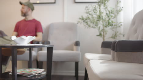 man in his 40s waits in a waiting room, slider. can be used for many subjects
