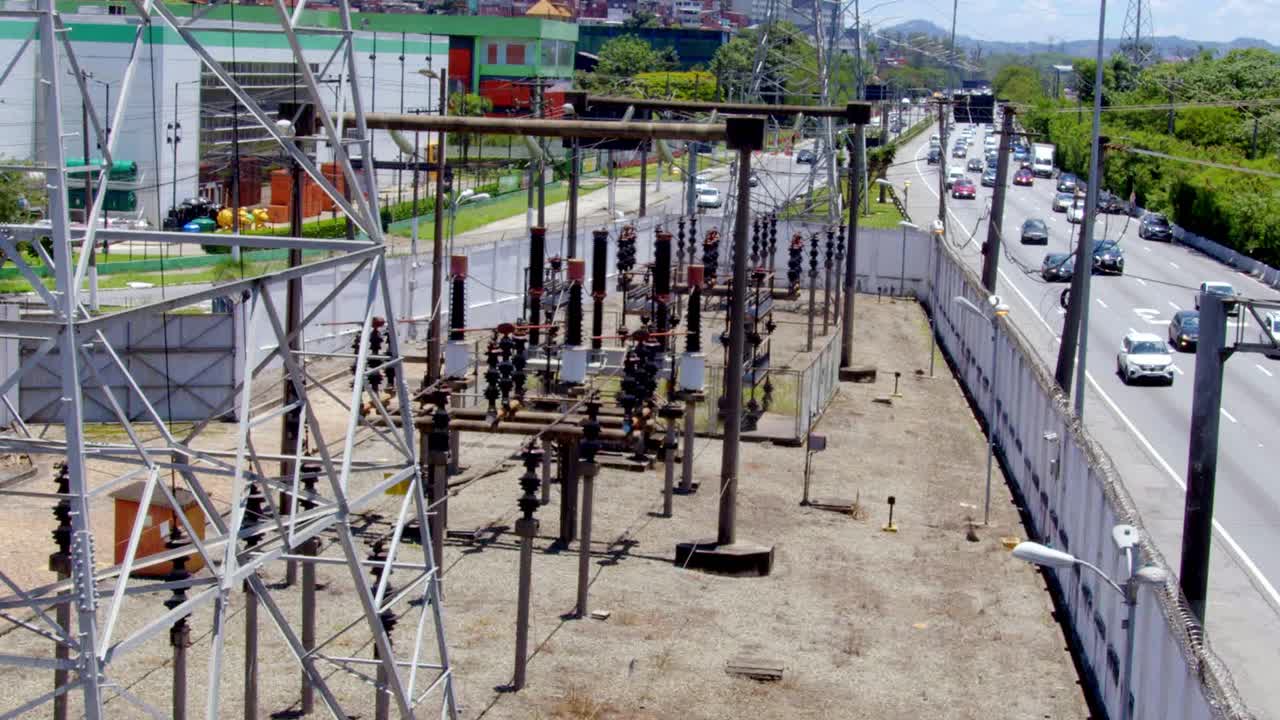 Stretched like threads across the sky, carrying sparks as cars rush by