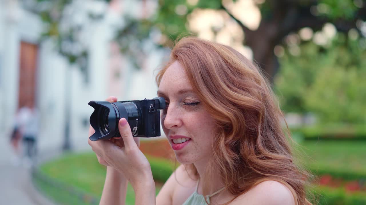 Red-haired Woman Taking Photos in a Park