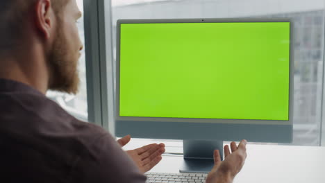 Gesturing freelancer virtual call chromakey monitor office. Man using mockup pc