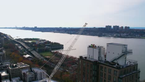 terrace roofing blue collar labor team next to flushing hudson river newyork