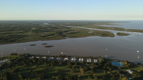 Aerial-establishing-shot-of-a-river-mouth-to-La-Plata-river-in-San-Isidro,-Buenos-Aires